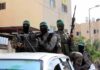Trump Claims Major Gaza Breakthrough armed masked men in military gear ride on a vehicle