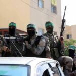 Trump Claims Major Gaza Breakthrough armed masked men in military gear ride on a vehicle