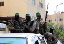 Trump Claims Major Gaza Breakthrough armed masked men in military gear ride on a vehicle