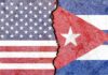Split wall showing USA and Cuba flags divided by a crack