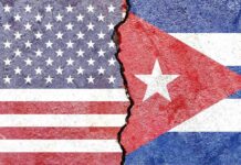 Cuban Spies Inside Pentagon? Split wall showing USA and Cuba flags divided by a crack