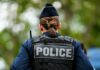 Connecticut Teens Escape Knife Attack Back view of a police officer wearing a uniform and a police vest