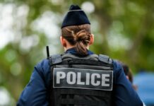 Connecticut Teens Escape Knife Attack Back view of a police officer wearing a uniform and a police vest