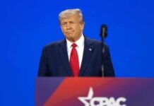 Trump Warns America About Communism A public figure speaking at a podium during a conference