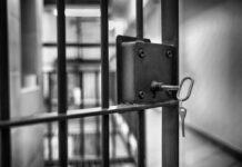 Deadly Prison Riot Kills Twenty-Five Close-up of a jail cell lock with a key hanging