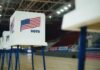Democrat Quits High-Stakes Senate Race Voting booths with American flags set up in a gymnasium