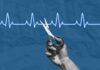 Historic Assisted Dying Law Approved A hand holding scissors above a heartbeat line on a blue background