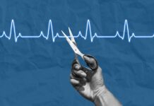 A hand holding scissors above a heartbeat line on a blue background