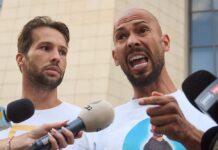 Tate Brothers Arrest Sparks Global Attention Judge with gavel striking sound block