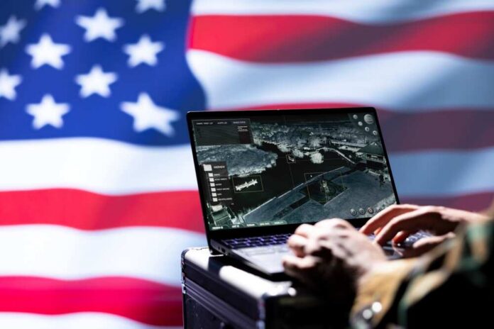 Laptop with surveillance software against a blurred American flag