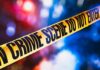 Bloody Clash Inside Posh Manhattan Building yellow crime scene tape with blurred police lights