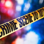 Bloody Clash Inside Posh Manhattan Building yellow crime scene tape with blurred police lights