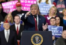 Trump’s Endorsement Tsunami Stuns 2026 politician speaking at a rally podium