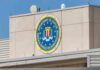 FBI emblem on a beige building facade