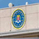 FBI emblem on a beige building facade