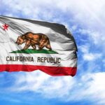 California state flag waving against a blue sky