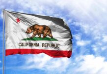 Holiday Power Play Roils School Boards California state flag waving against a blue sky