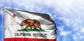 California state flag waving against a blue sky