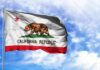 Newsom’s Budget Balance Hides A Bigger Problem California state flag waving against a blue sky