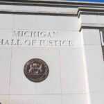 Records Fight Explodes Around Top Election Chief Michigan Hall of Justice exterior wall with state seal