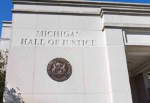 Records Fight Explodes Around Top Election Chief Michigan Hall of Justice exterior wall with state seal