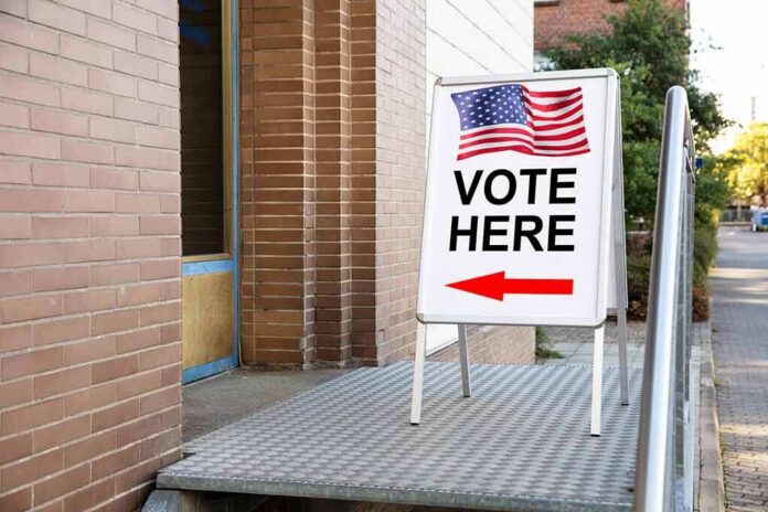 Sidewalk sign with American flag directing to a polling place