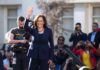 Pricey Malibu Buy Triggers Equity Backlash woman in navy suit waving at outdoor event