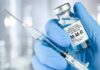 Trump Pushes Major Vaccine Policy Review Gloved hands holding a vaccine vial and syringe