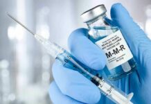 Trump Pushes Major Vaccine Policy Review Gloved hands holding a vaccine vial and syringe