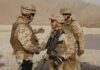 Border Raids Ignite — U.S. Joins The Hunt Soldiers in desert uniforms shake hands outdoors