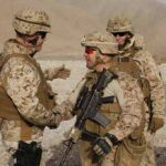 Border Raids Ignite — U.S. Joins The Hunt Soldiers in desert uniforms shake hands outdoors
