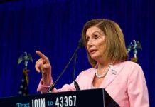 Pelosi’s Endorsement Ignites Bitter Democratic Fight woman in pink suit speaking at a podium