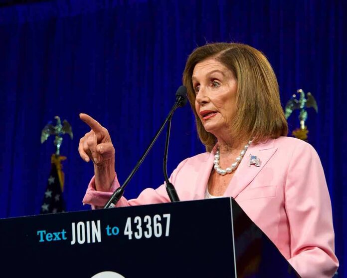 shutterstock_1486755941 woman in pink suit speaking at a podium