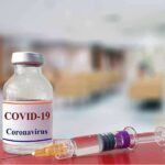 vaccine vial and syringe on a counter in a clinic
