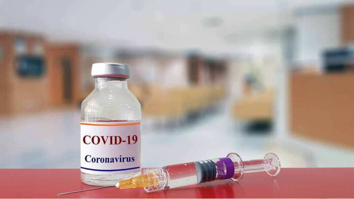 vaccine vial and syringe on a counter in a clinic