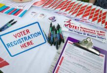 Court Smacks Ohio’s Citizenship Check Voter registration table with forms, pens, and informational materials