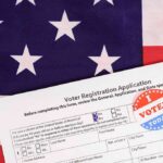 633,000 Arizona Voter Files Hacked Voter registration form with I Voted sticker on American flag