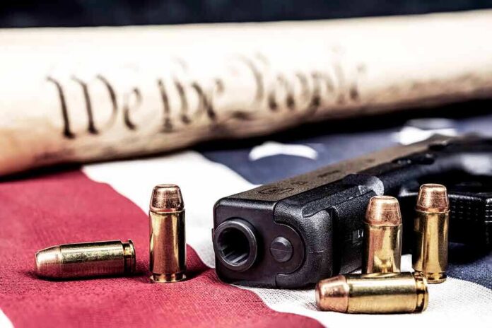 Handgun with bullets on American flag near parchment