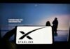 Ukraine Gives Musk Its Highest Civilian Honor Smartphone showing Starlink logo in front of a computer screen