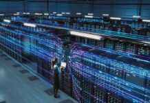 County’s Tax Windfall Faces A New Threat Technician with laptop in a large data center aisle