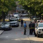 Afternoon Walk Turns Multi‑State Mystery Police officers secure a residential street with patrol cars and yellow tape