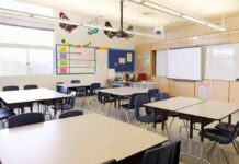 School Guide Sparks Fight Over Bin Laden Empty classroom with tables, chairs, and a whiteboard