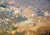 Houthi Drone Targets Saudi Airport Aerial view of desert city with airport and highways