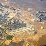 Aerial view of desert city with airport and highways