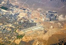 Houthi Drone Targets Saudi Airport Aerial view of desert city with airport and highways