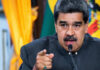 Man speaking passionately and gesturing during a speech.