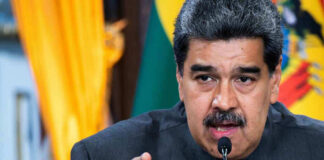 Man speaking passionately and gesturing during a speech.