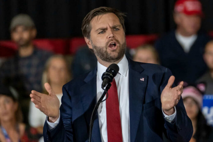 54801cb8-0515-4c34-a2d8-f79705e6683e_shutterstock2542628059jpg Man in suit speaking at a podium
