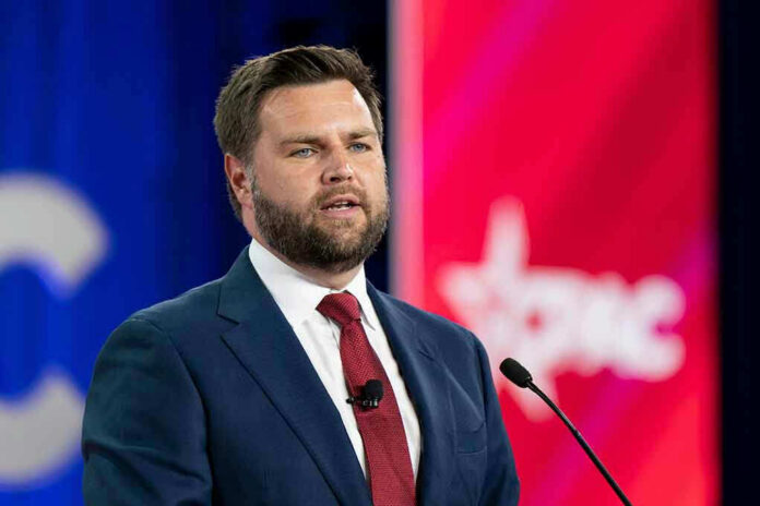 c0e4d3fd-3b50-4cd9-b02f-4e9933d13d92_2186937099.jpeg Man in suit speaking at a podium with microphone