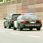 Governor Steps In After Explosive ICE Crash Police car with flashing lights stops a minivan on highway